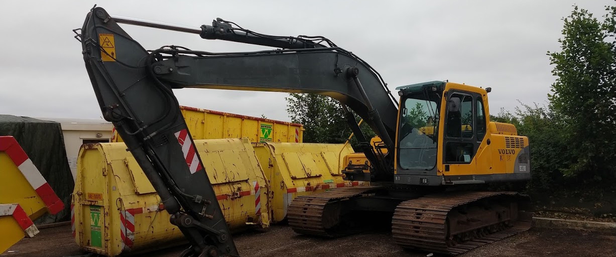 Volvo EC210-rupskraan tussen de gele containerbakken op de kijkdag